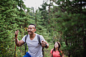 Happy couple hiking in woods