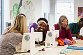 Fashion designers working at sewing machines