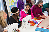 Fashion designers using sewing machines