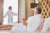Mature couple in bathrobes relaxing