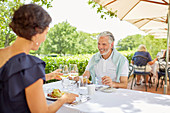 Mature couple dining at patio table