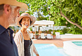Happy mature couple at resort poolside