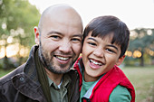 Portrait happy father and son in park