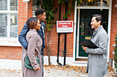 Real estate agent talking with couple