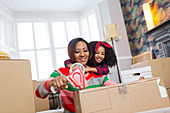 Affectionate mother and daughter packing, moving house