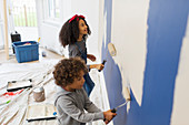 Brother and sister painting wall