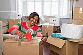 Portrait smiling, woman taping cardboard box