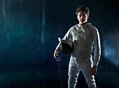 Portrait confident teenage boy fencing