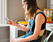 Young female college student studying with flash cards