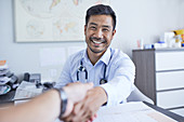 Point of view happy doctor shaking hands with patient