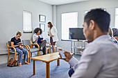 Doctor and patients in clinic waiting room