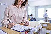 Woman filling out medical insurance paperwork