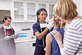 Female pediatrician examining girl patient