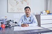 Portrait male doctor working in clinic doctors office