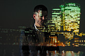Businessman and cityscape at night