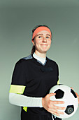 Teenage girl soccer player holding ball