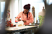 Female fashion designer with fabric in studio