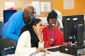 Professor and college students using computer