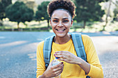 Portrait happy, confident young woman with water bottle