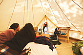 Curious kids peeking inside camping yurt