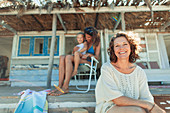Multi-generation women on beach hut patio