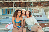 Multi-generation women outside beach hut