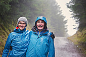 Father and son hiking in rain
