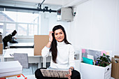 Businesswoman using laptop in new office