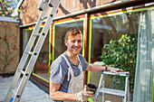 Portrait male painter with ladder painting