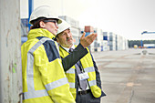 Dock manager and worker talking at shipyard