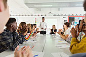 Students clapping for classmate in debate class