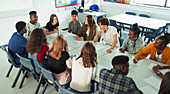 High school students talking at table in debate class