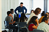 Students and teacher using computers in computer lab