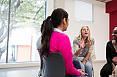 Woman talking in support group meeting circle