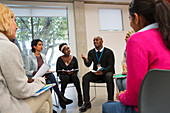 Man talking in support group meeting circle