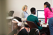 Instructor helping students in computer lab
