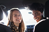 Portrait happy young couple in car
