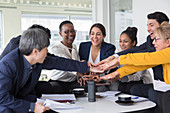 Business people joining hands in meeting