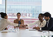 Businesswomen shaking hands in conference room meeting