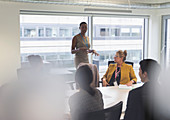 Businesswoman leading conference room meeting