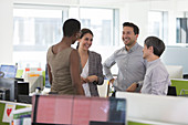 Smiling business people talking, meeting in office