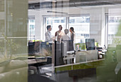 Business people talking, meeting in open plan office