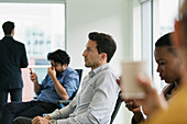 Attentive businessman listening in conference room meeting