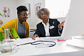 Doctor meeting with patient at computer in doctors office