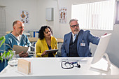Doctors and administrator meeting at computer