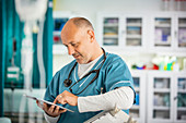 Male doctor using digital tablet in hospital