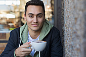 Portrait young man drinking cappuccino