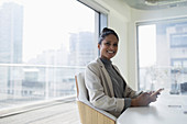 Portrait happy, businesswoman in conference room
