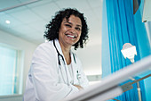 Portrait confident, female doctor in hospital room