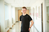 Portrait high school boy in corridor